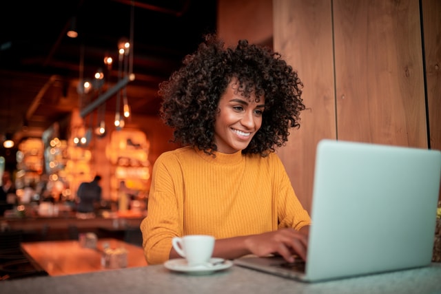 woman working on her laptop in a coffee shop