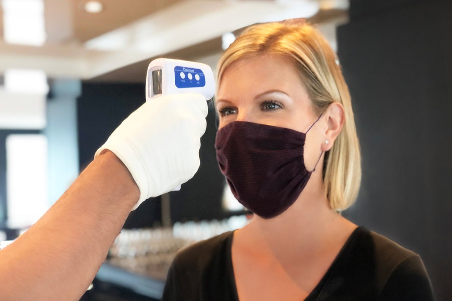 Woman getting temperature taken  