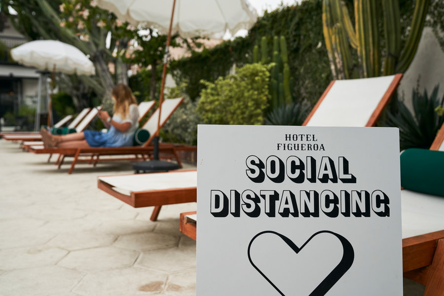  Pool Chairs with Social Distancing sign in view