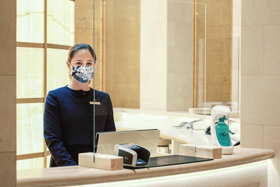  woman at front desk with mask 