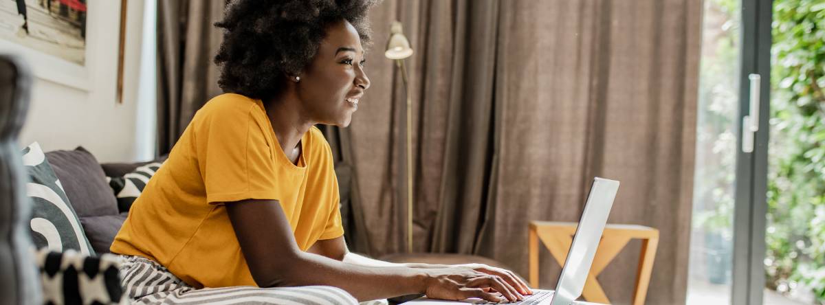 Woman writing down information in her living room