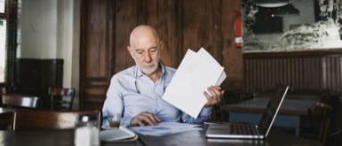 Older man looking through papers