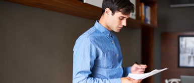 young man reading document