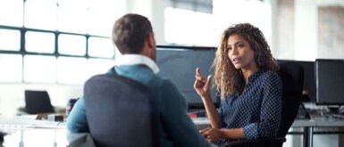 Woman discussing with colleague