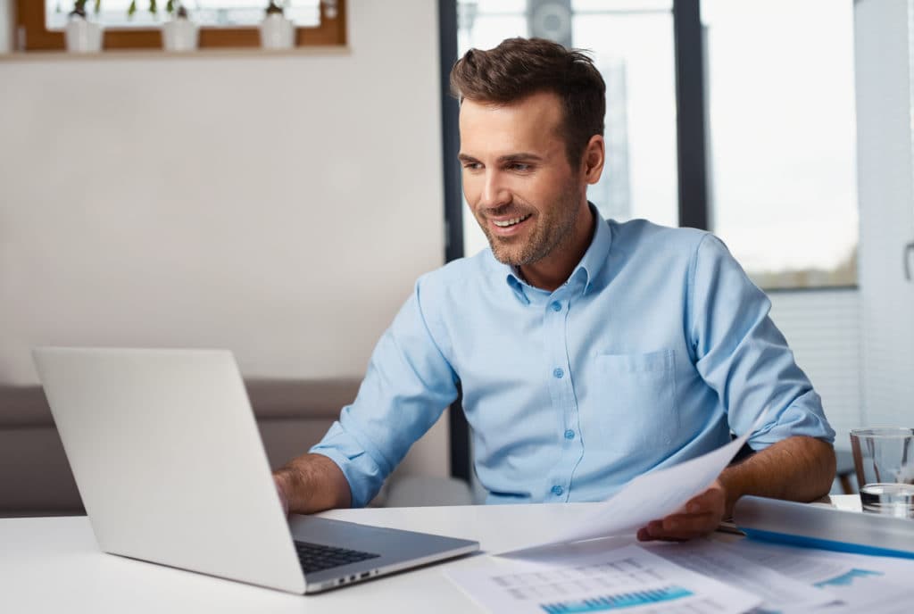Man looking at business details on computer.