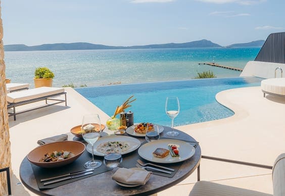 Poolside dining with ocean view and gourmet dishes
