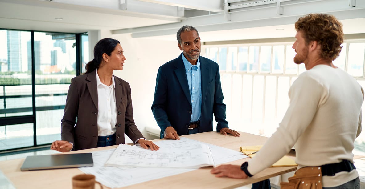 Professionals discussing building plans with contractor