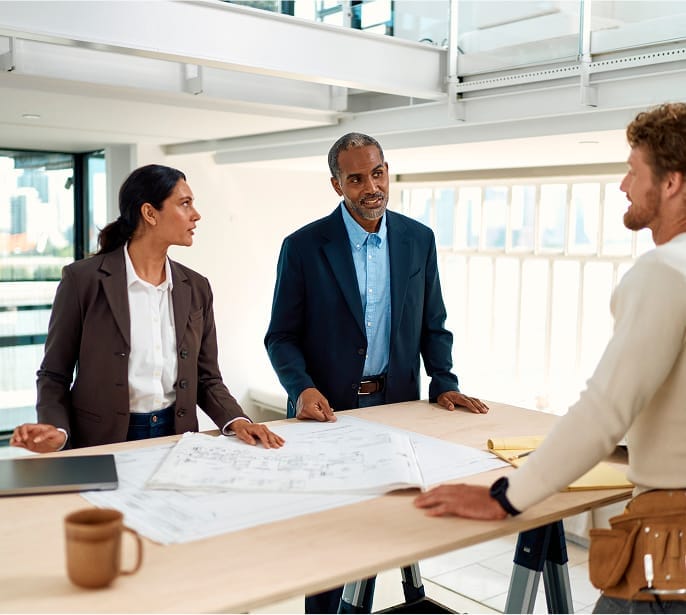 Professionals discussing building plans with contractor