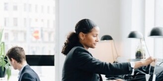 Black woman and white man working in an office