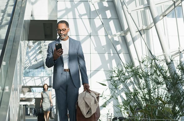 Person waiting in airport on their phone
