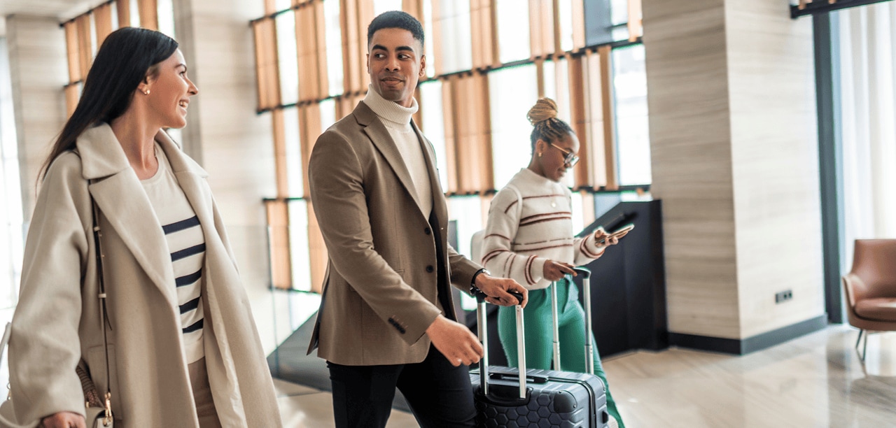 Colleagues in a lobby with suitcases