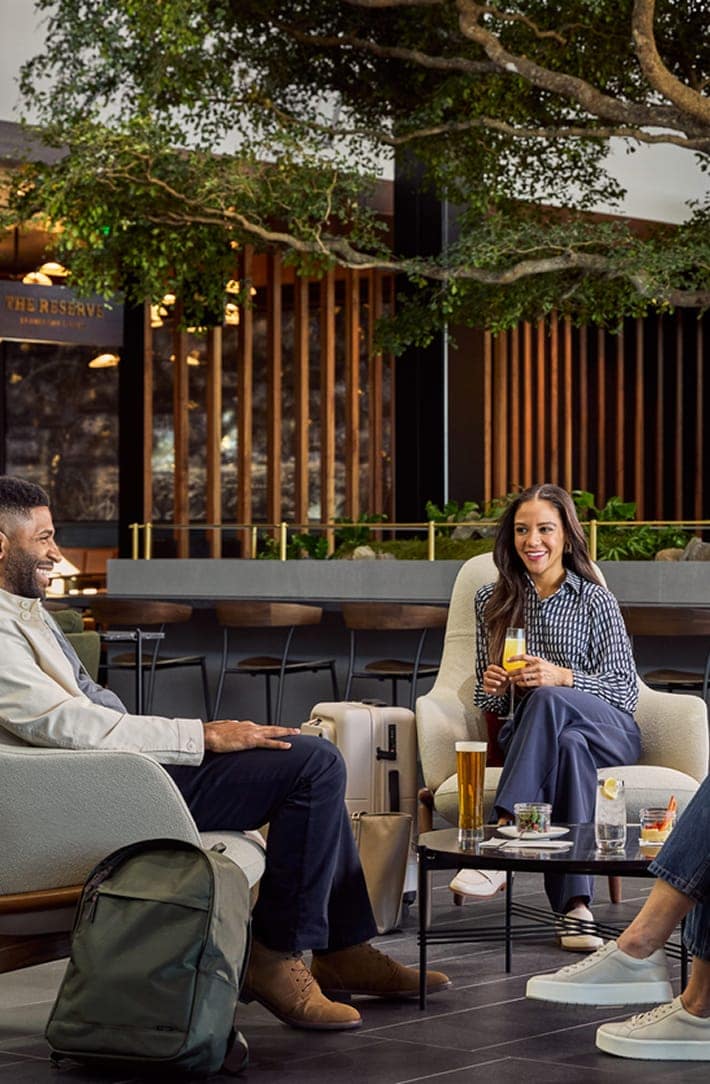 People enjoying a lounge with the GLC logo