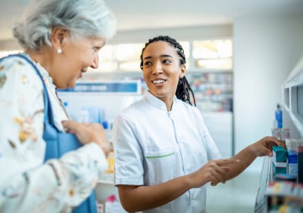 Pharmacist discussing medication with customer