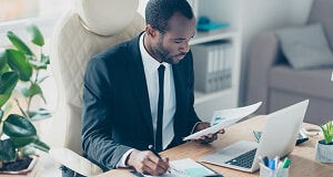 Man reviewing business charts in private office