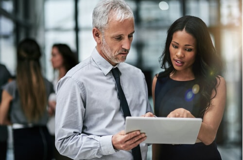 Man and woman reviewing information on a tablet