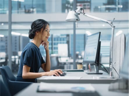 Woman working at desktop computer in office