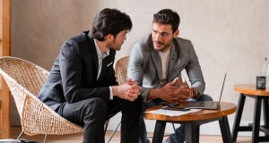 Two men in deep discussion in a café