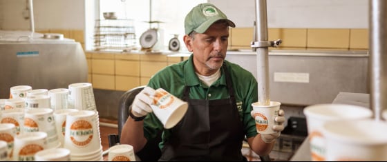 Adirondack Creamery worker filling cups through nozzle