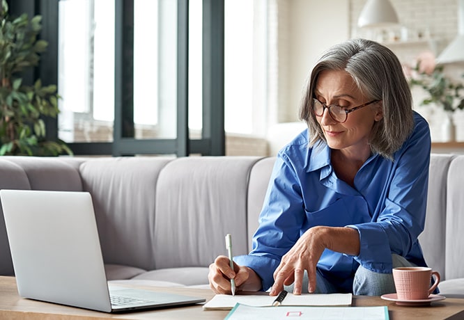 An employee writing down tips from a Business Class article. 
