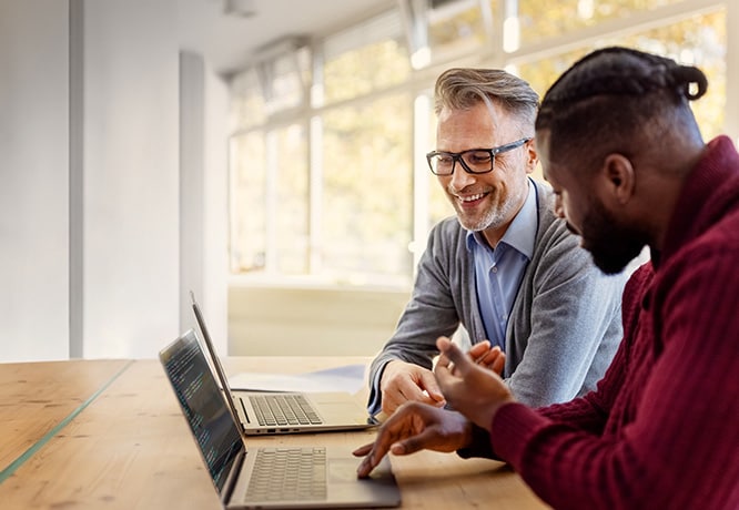 Two employees discussing a Business Class podcast they listened to together