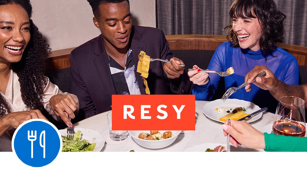 Employees enjoying a company dinner booked through Resy and a dining icon.