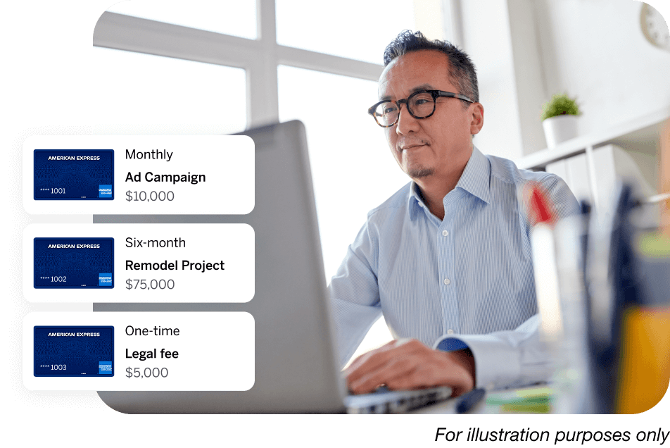 Man with glasses in an office working on a laptop computer 