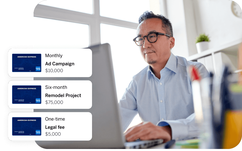 Man with glasses in an office working on a laptop computer. Three virtual card graphics are shown on the left of the image representing the different types of virtual cards that are available to One AP customers. 