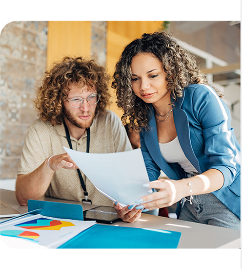Image of two people looking at a paper