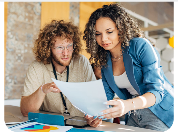Image of two people looking at a paper