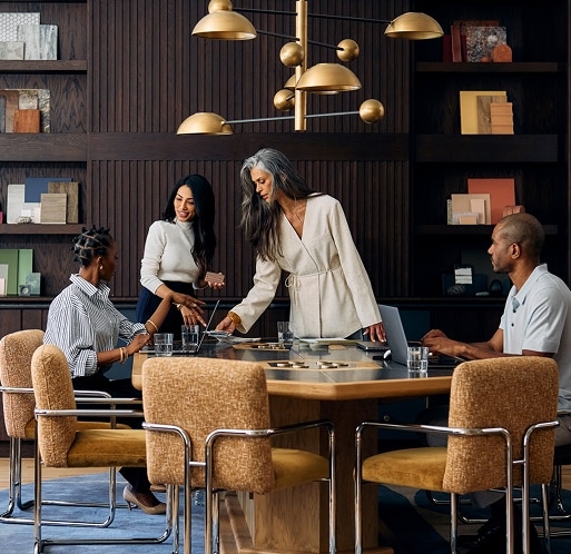 Four people around a table having a business meeting