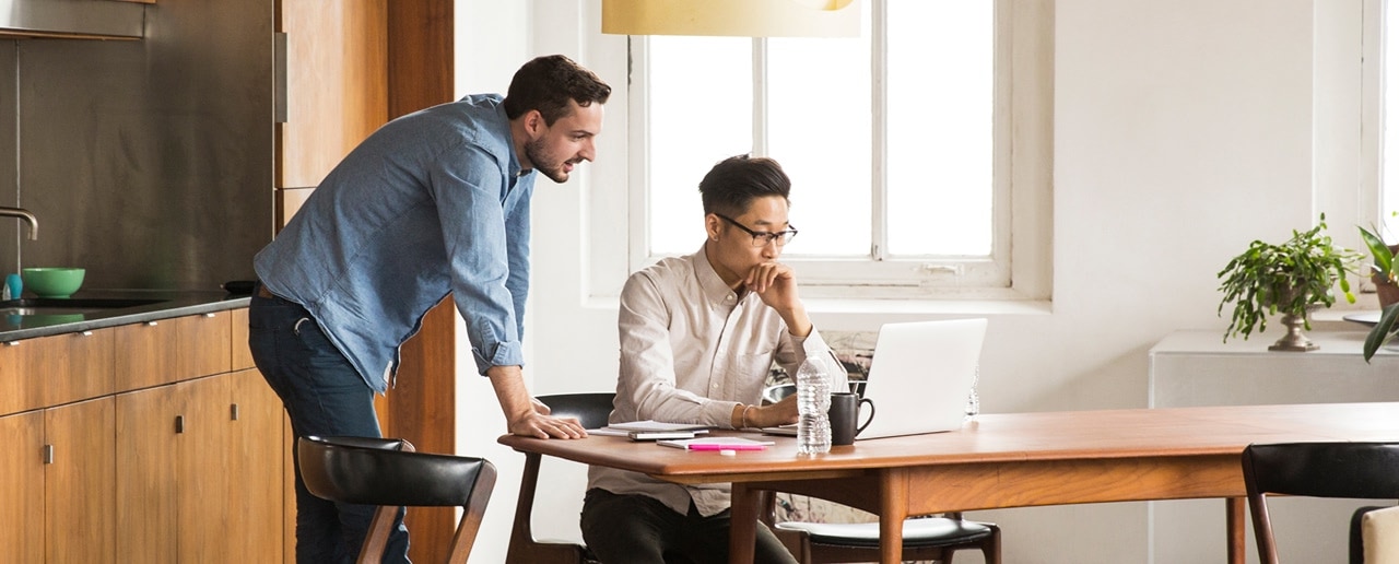 Two people looking at a laptop