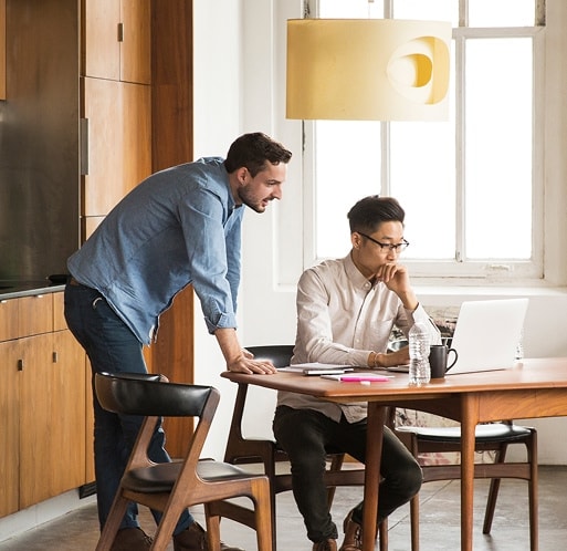 Two people looking at a laptop