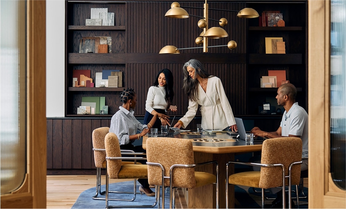 Four people around a table having a business meeting