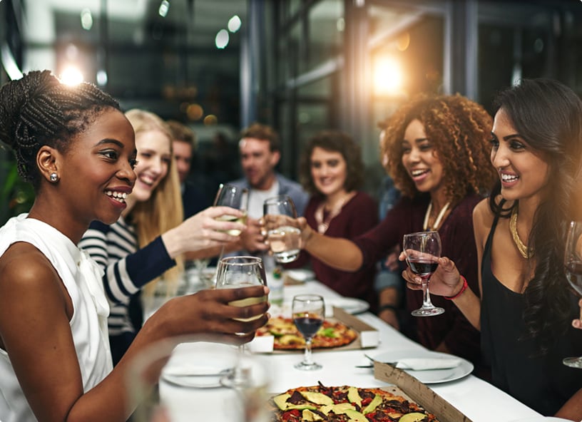 Group of friends at a long table eating