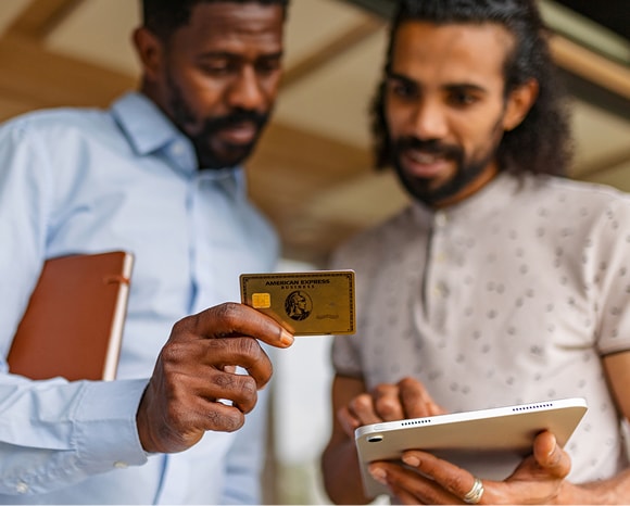 Two businessmen making a purchase on tablet with the Business Gold Card.