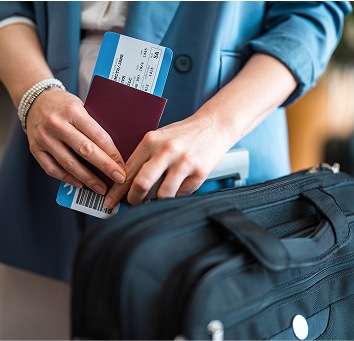 Person holding their boarding pass and passport.