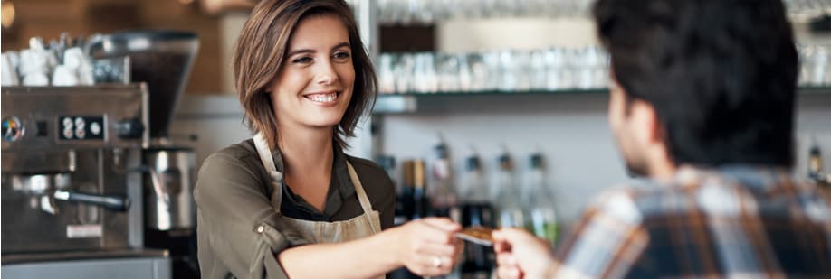 Barista receiving credit card from customer