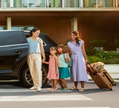 Business woman in a car looking at a tablet