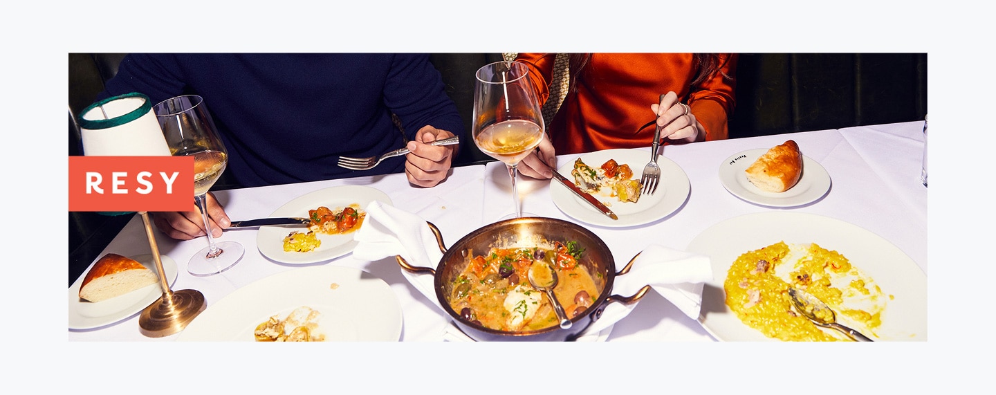 Bird’s-eye view of two people dining on entrees.