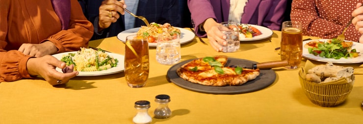Two colleagues reviewing a laptop in a storefront