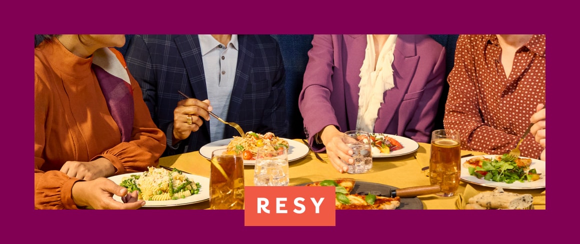 Two colleagues reviewing a laptop in a storefront