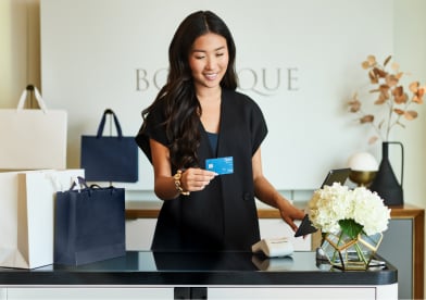 Woman typing on a laptop outdoors.