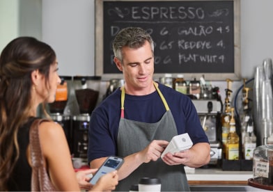 Two colleagues reviewing paperwork at an office table.
