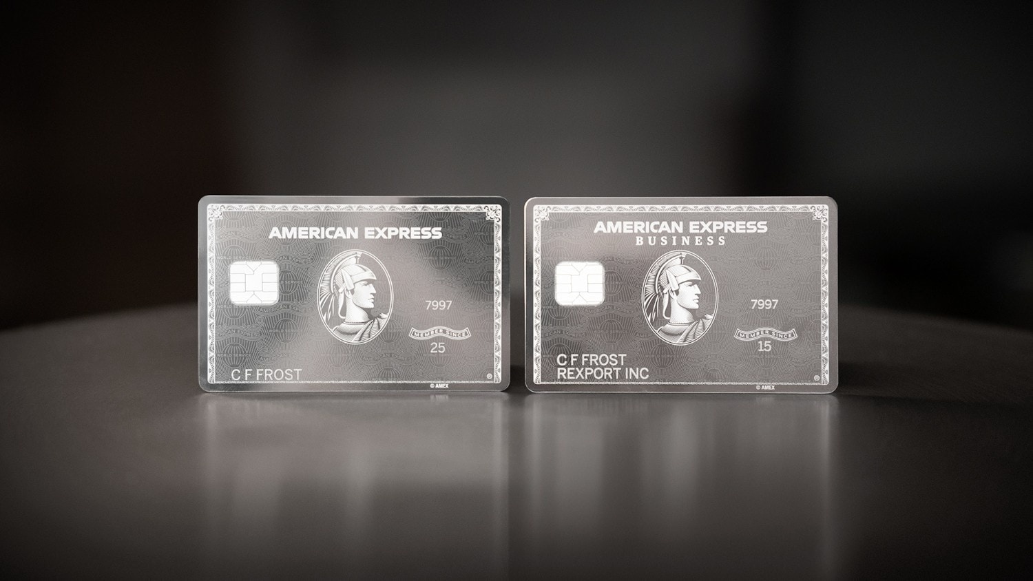 The American Express Platinum Consumer and Business Cards are displayed side by side against a dark background.