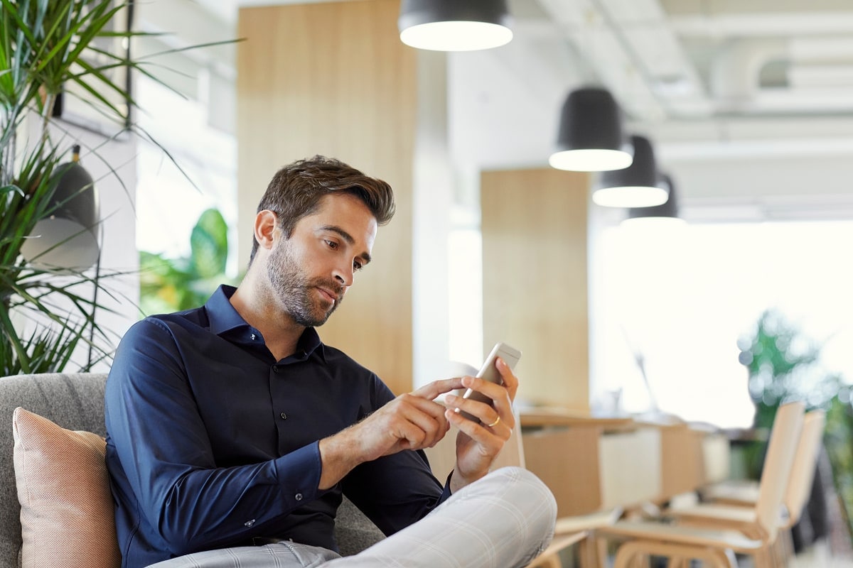 A professional image of a person using a mobile banking app to make a credit card payment, with a calendar in the background.