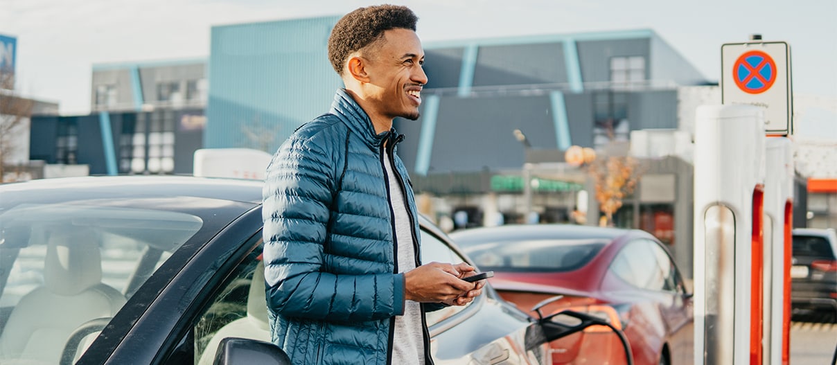 Someone charging an electric car at a charging station