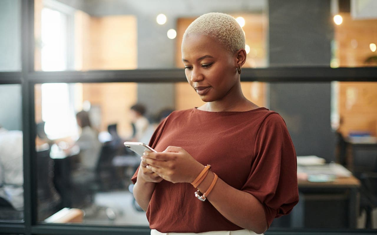 A professional image of a person using a mobile banking app on their smartphone.