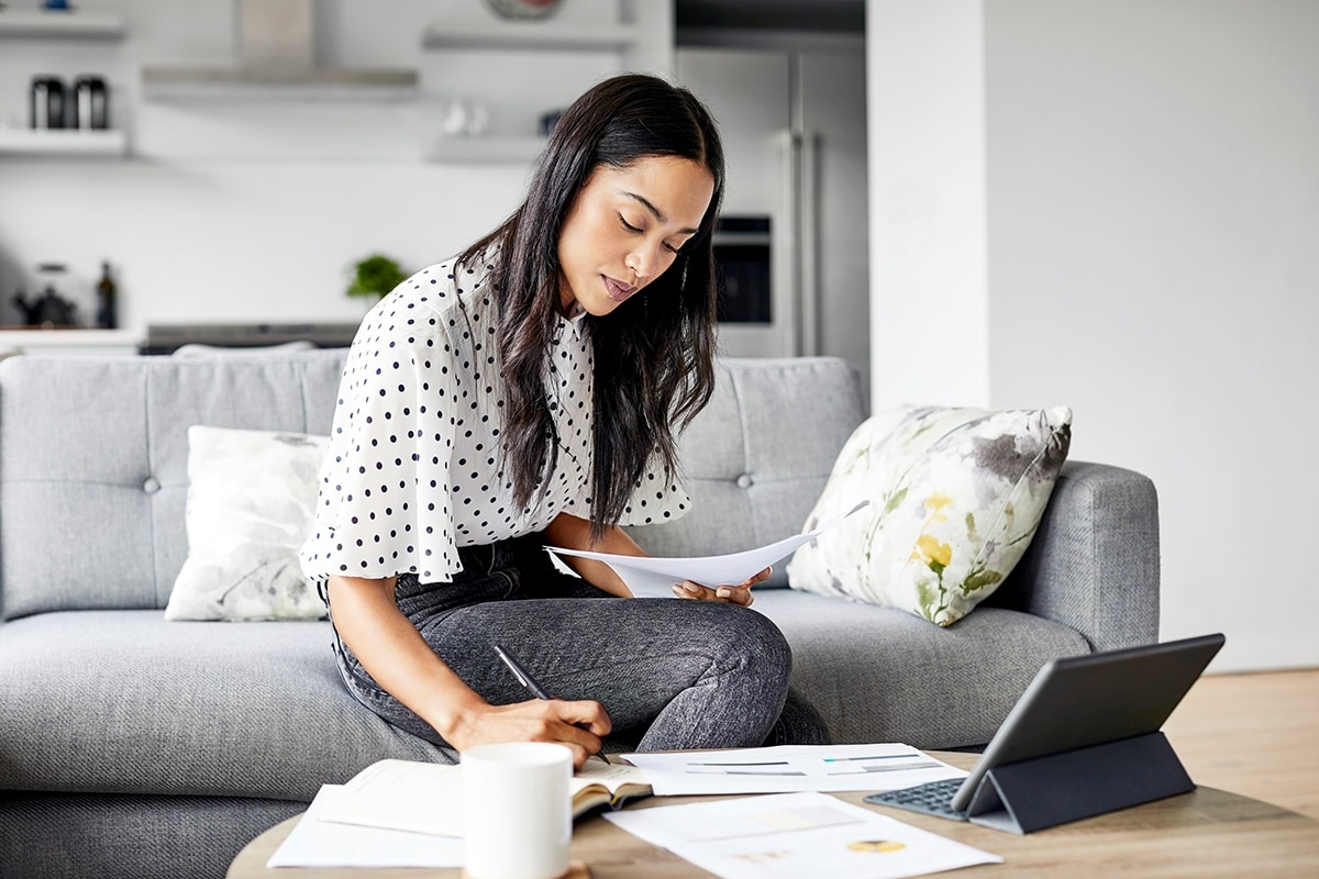 Someone holding a student loan bill and a credit card