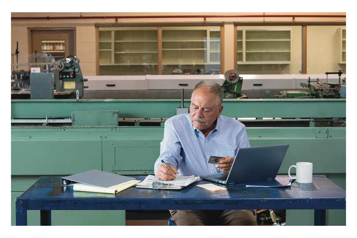 A person looking at multiple credit cards, concentrating as if making a plan
