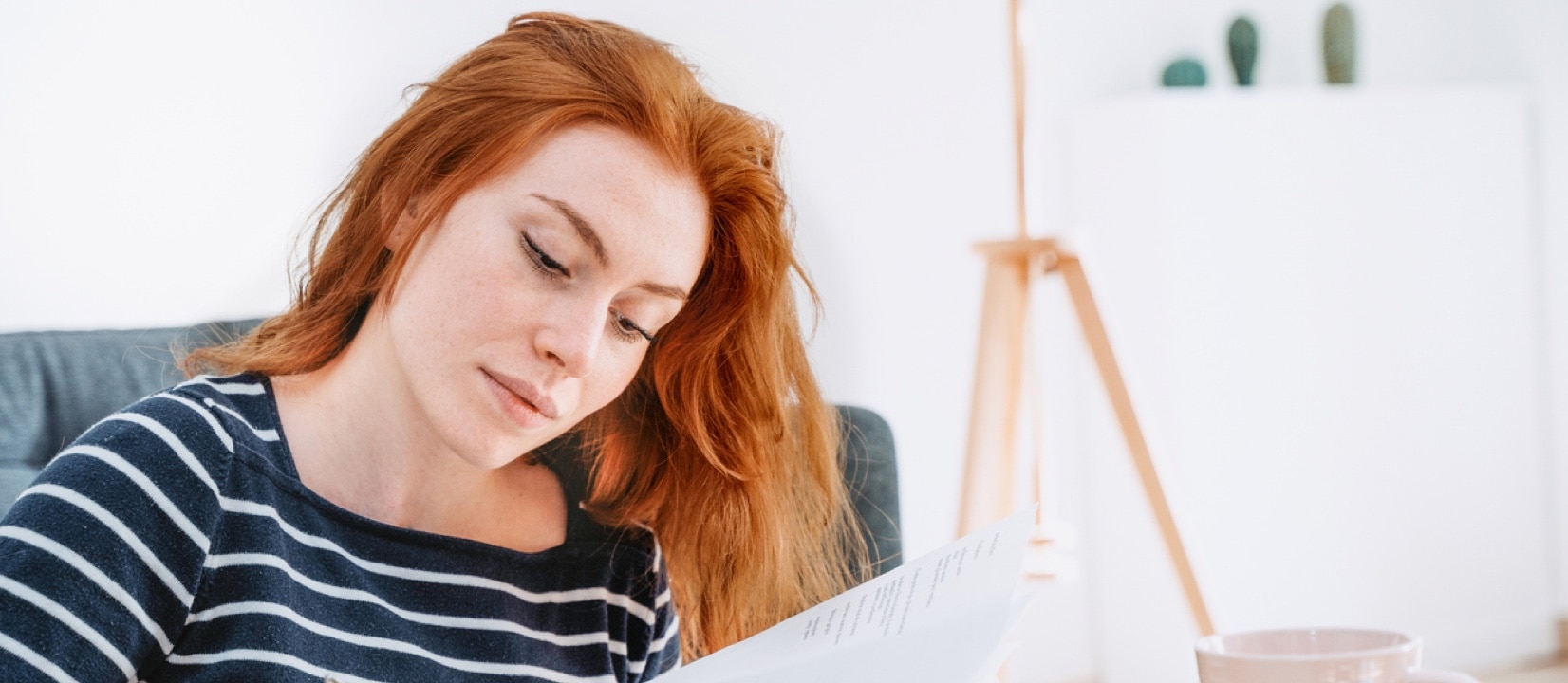 A woman sitting at a desk writing on papers